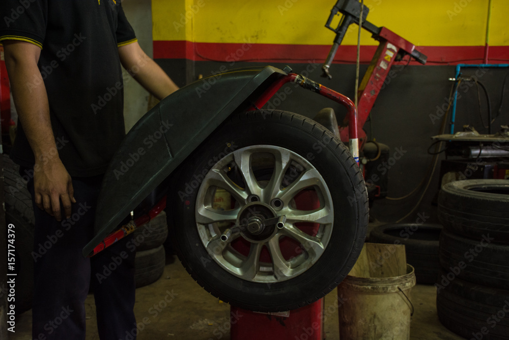A process balance of new tire replacement at service station, mechanic changing a wheel and tires
