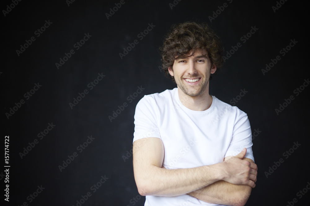 Trust me. Studio portrait of a confident young man looking honestly while standing against a black bacgkround. Trust me. Studio portrait of a confident young man looking honestly while standing against a black bacgkround.