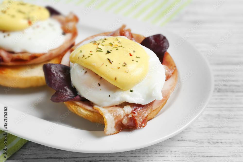 Tasty eggs Benedict with avocado on plate
