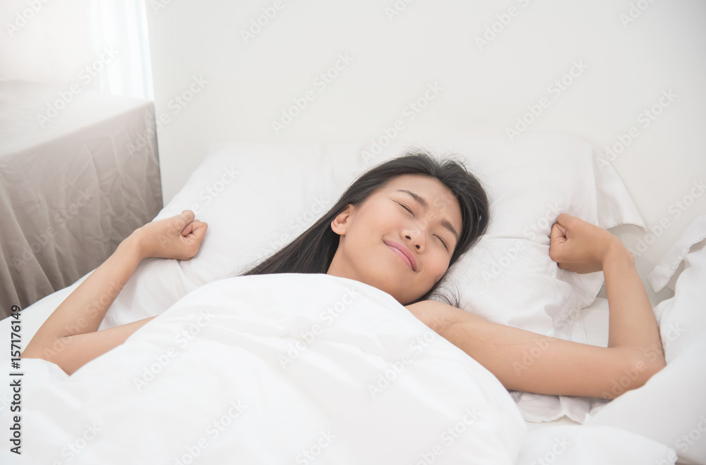 Beautiful Asian woman waking up on her bed in the morning. Beautiful Asian woman waking up on her bed in the morning.