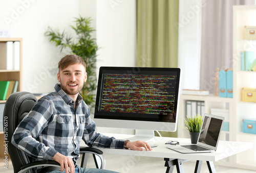 Young programmer at workplace