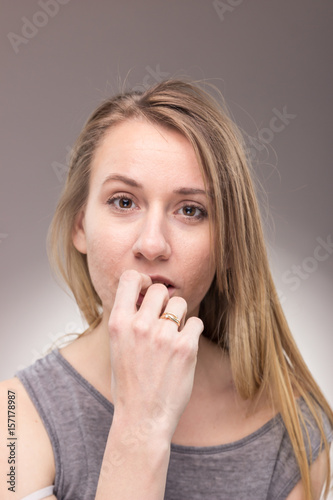 one young woman, looking to camera, portrait background