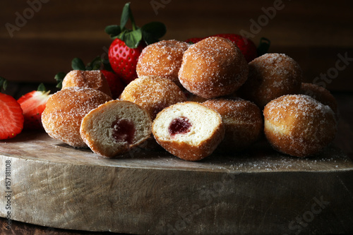 Bomboloni - traditional Italian doughnuts stuffed with strawberry jam photo