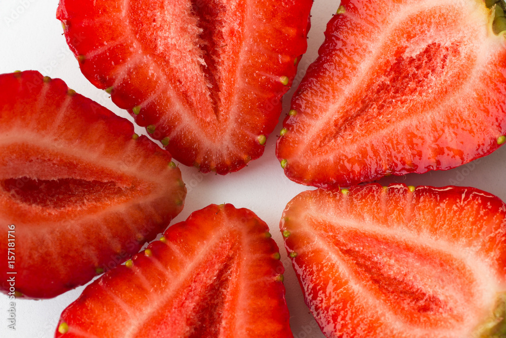 halves of a strawberry on a white background. top view. halves of a strawberry on a white background. top view.