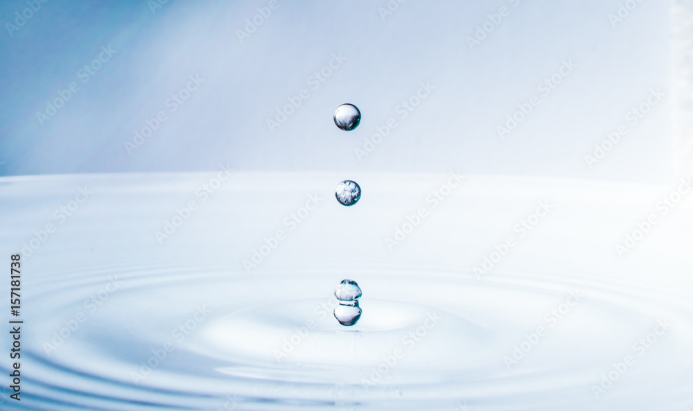 close up blue water drop falling down close up blue water drop falling down
