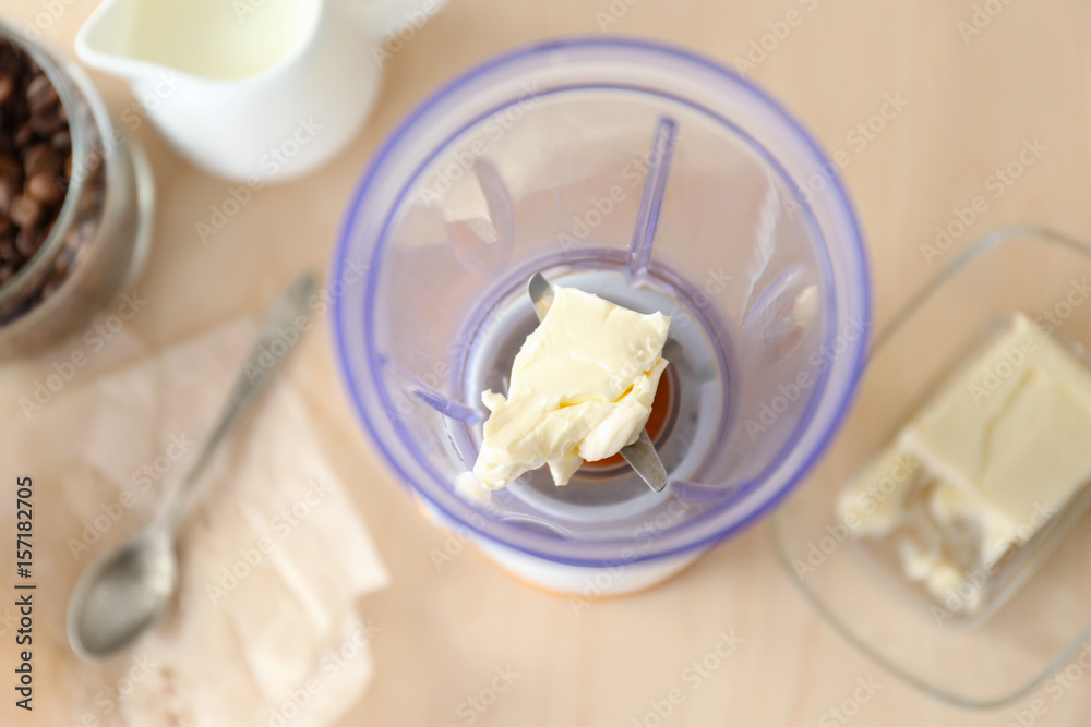 Blender cup with butter on table Blender cup with butter on table