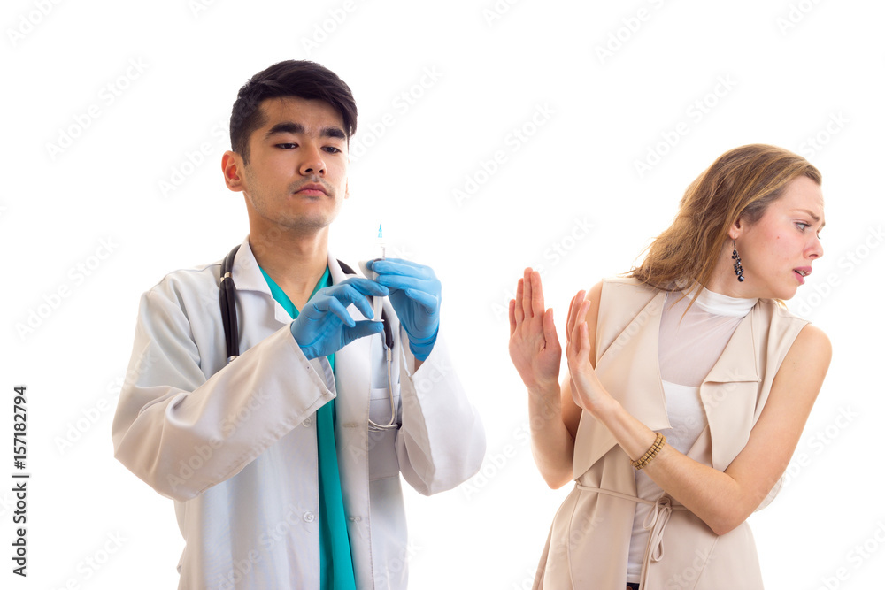 Young doctor preparing for injection of young woman Young doctor preparing for injection of young woman
