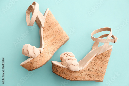 Pair of beautiful shoes on color background photo