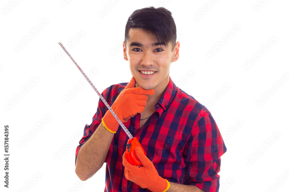 Young man in gloves holding tape-measure Young man in gloves holding tape-measure