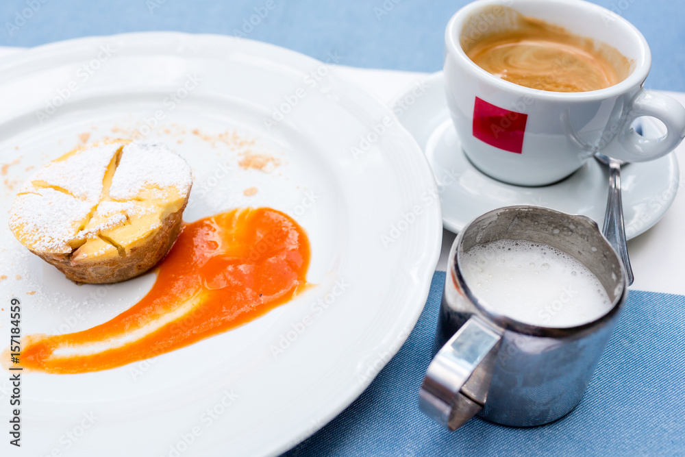 Viennese Apple strudel with fruit sauce on a plate. not a classic shape in a unique way. a Cup of coffee and a warm frothed milk