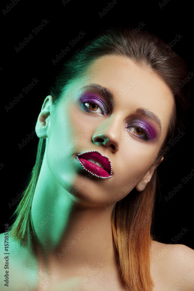 Fototapeta premium Beautiful young woman with creative makeup on dark background