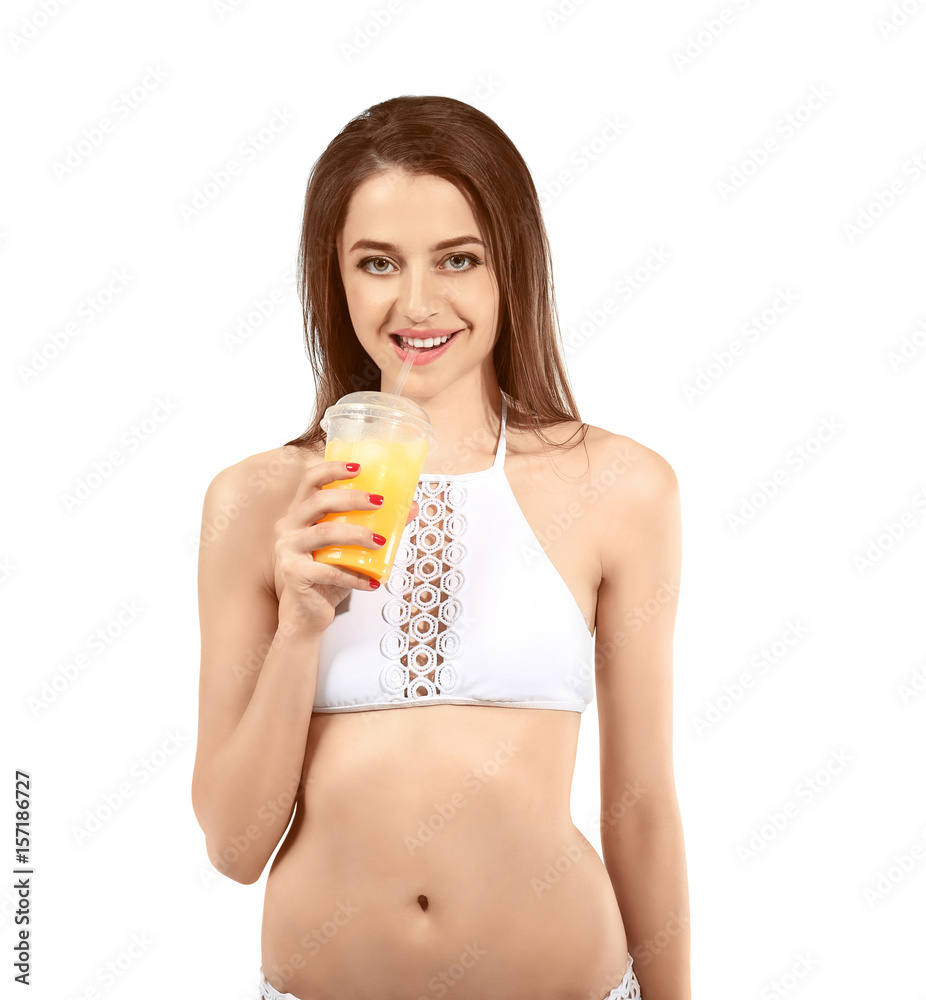Beautiful young woman in swimsuit drinking juice on white background Beautiful young woman in swimsuit drinking juice on white background