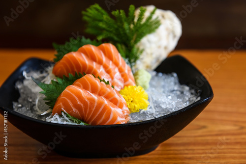 Fresh salmon sashimi on wooden table