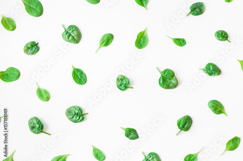 Spinach leaves on white background. Pattern made of spinach. Flat lay, top view