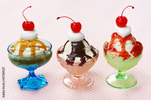 Bild auf Leinwand Three Ice Cream Sundaes with Whipped Cream and Cherries
