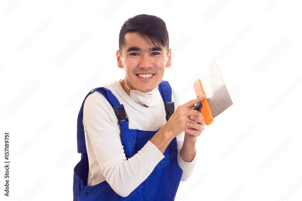 Man in blue overall with respirator holding spatula Man in blue overall with respirator holding spatula