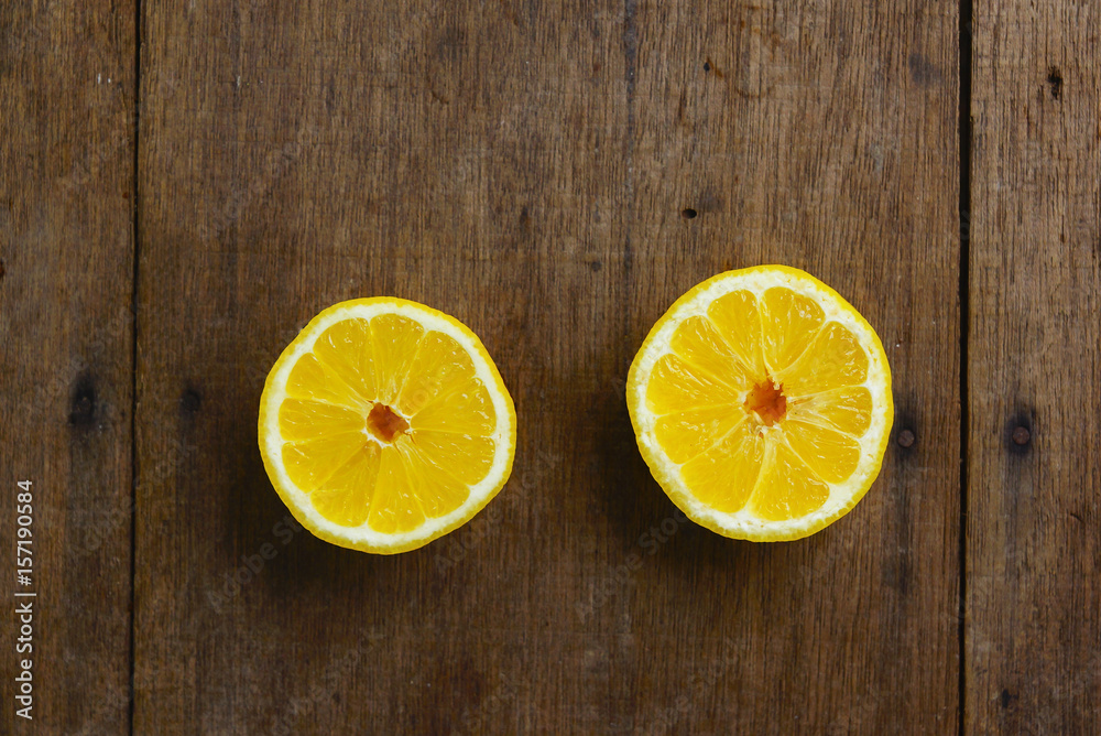 Yellow Fresh Lemon Slice Over Wooden Background