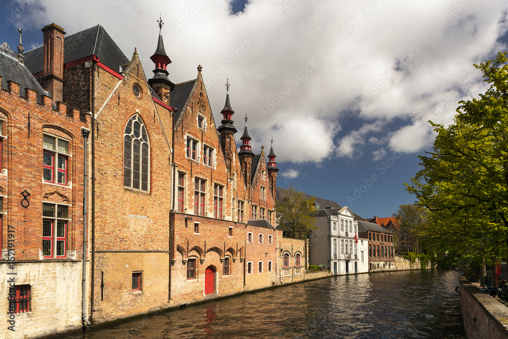 Exterior of historical towers and houses in Bruges city, Belgium