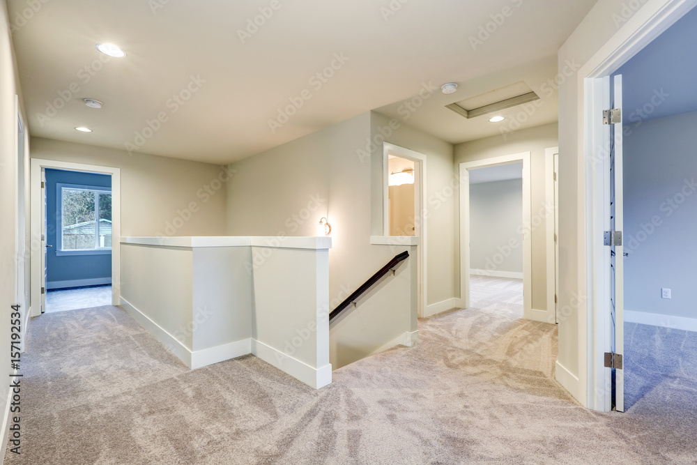 Second floor landing with creamy walls and beige carpet floor
