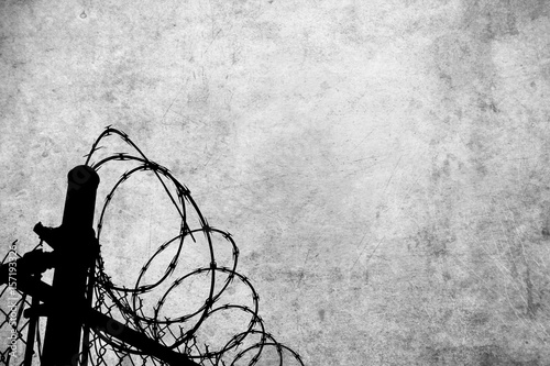 Grunge background with barbed wire fence