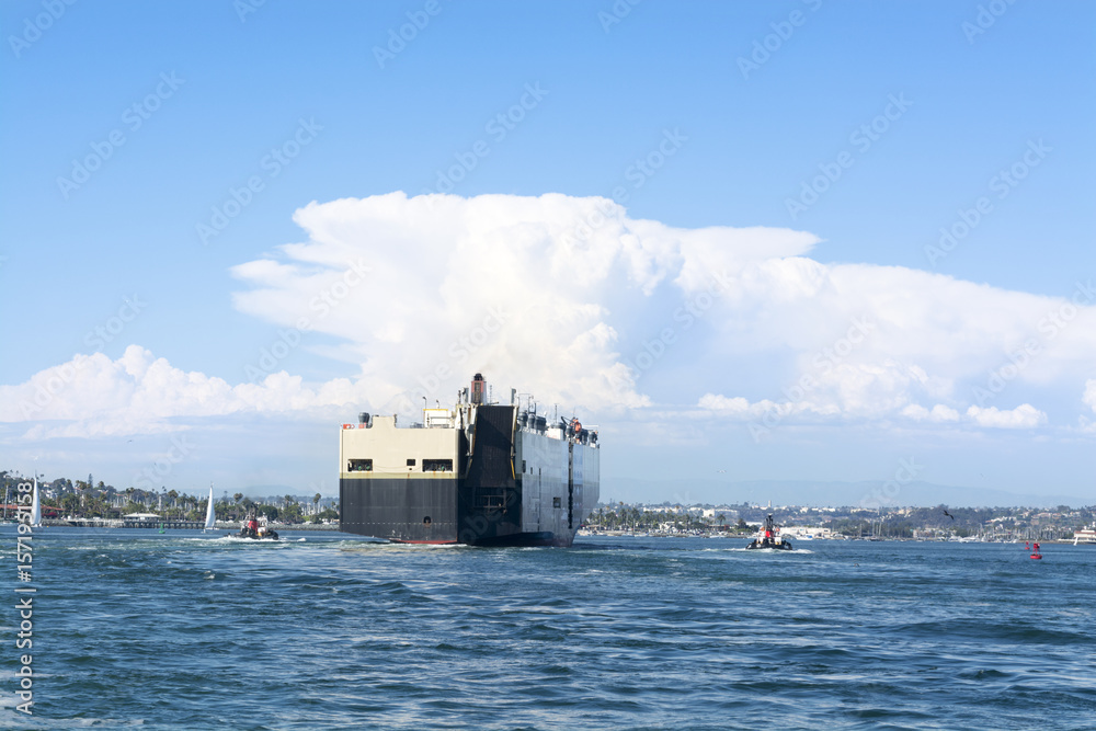 Freighter guided by tugboats