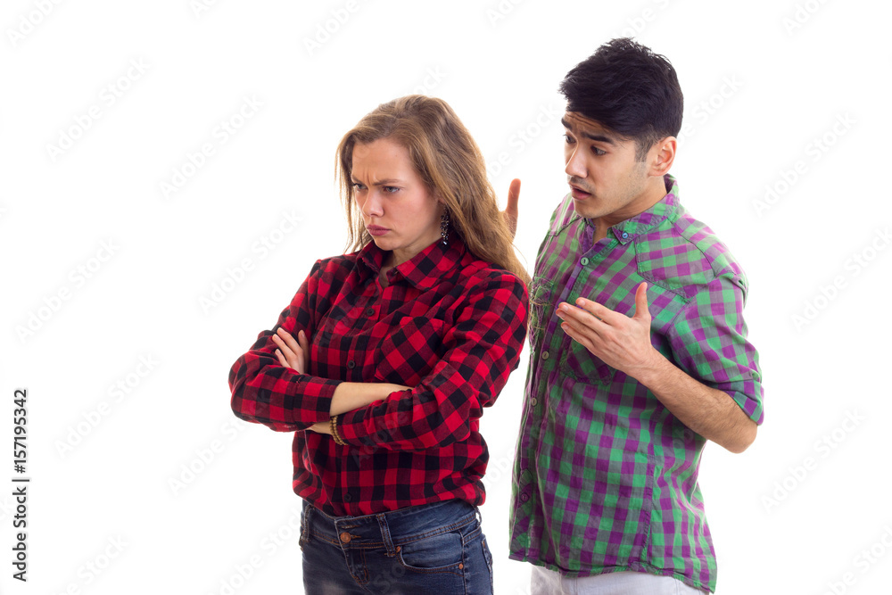 Young couple in plaid shirts arguing Young couple in plaid shirts arguing