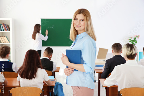 Female teacher with noteboo...