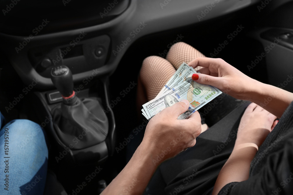 Ταπετσαρία Young prostitute receiving money from client in car