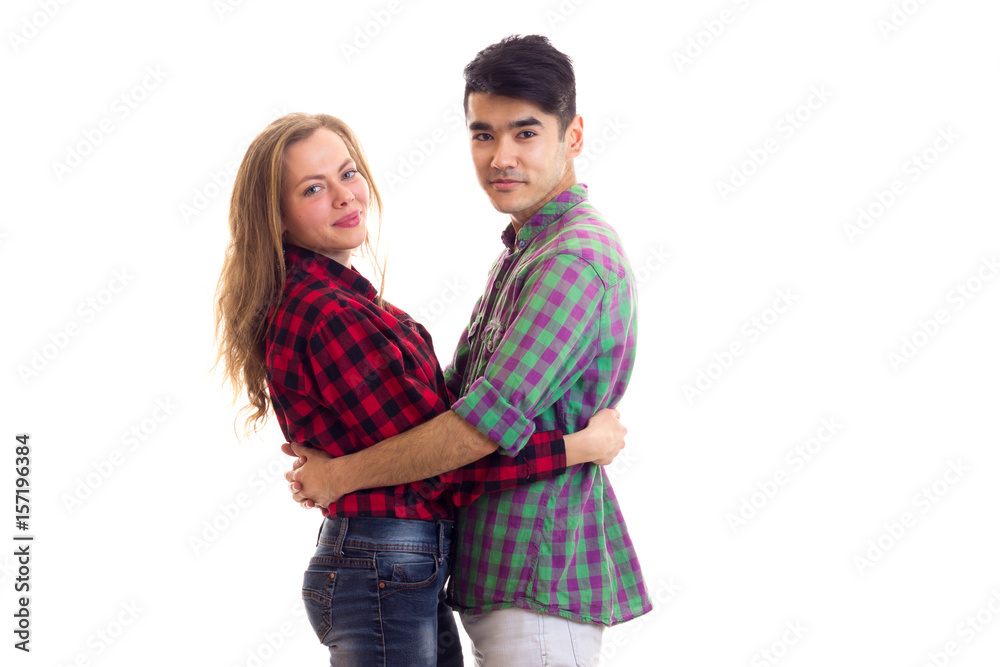 Young couple in plaid shirts hugging Young couple in plaid shirts hugging