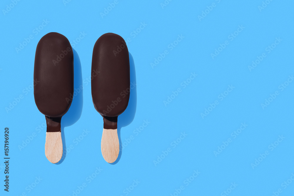 Dark chocolate ice-cream bars on bright blue background Dark chocolate ice-cream bars on bright blue background