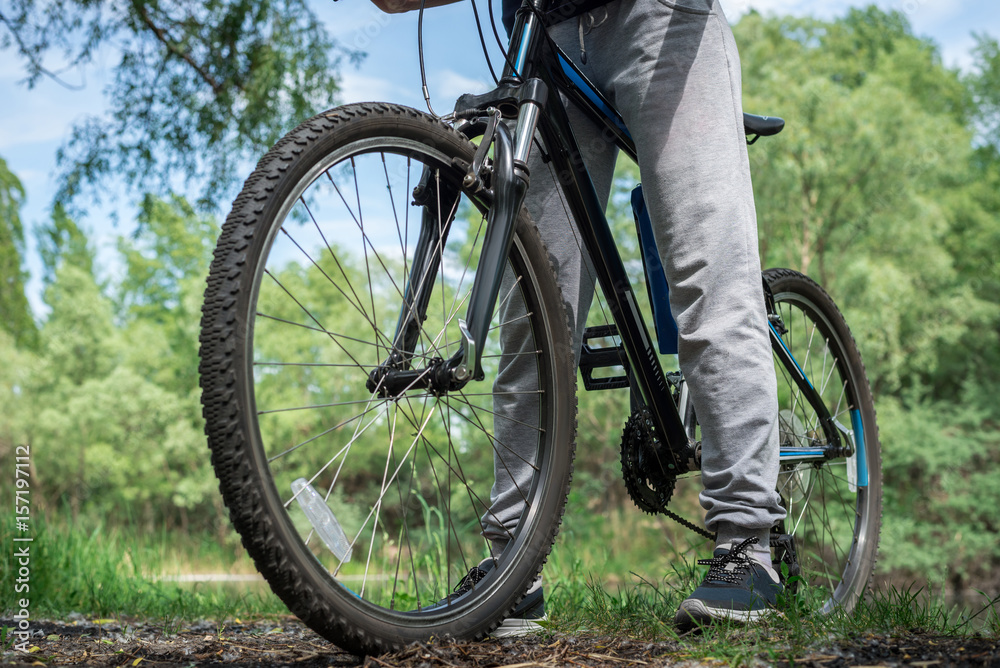 Relax on a mountain bike ride along the forest path. Sports and the concept of active life in the summer. Horizontal frame Relax on a mountain bike ride along the forest path. Sports and the concept of active life in the summer. Horizontal frame