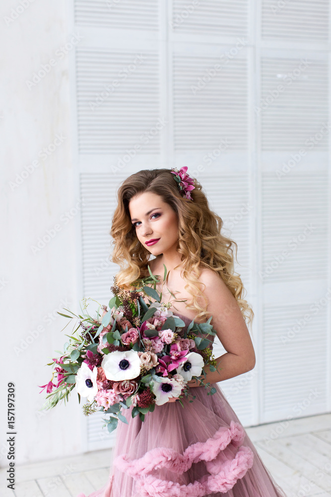 Fashion portrait. Beautiful woman with bouquet.