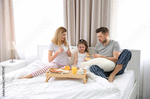 Happy family having breakfa...