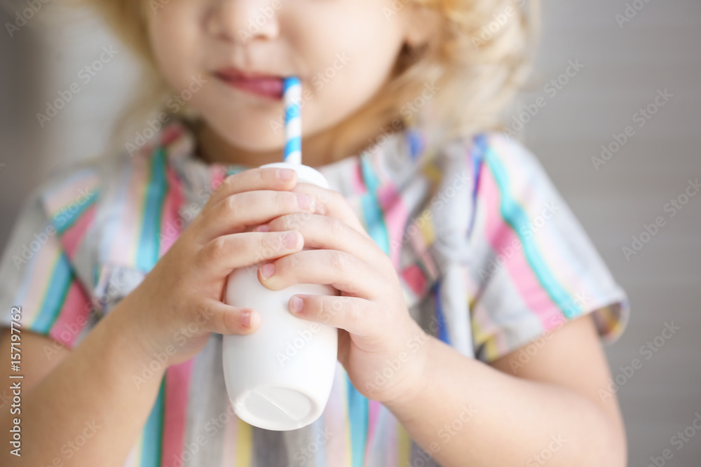 Cute little girl drinking yogurt at home, closeup Cute little girl drinking yogurt at home, closeup