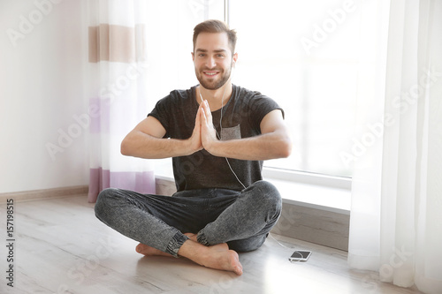 Young man practicing yoga n...