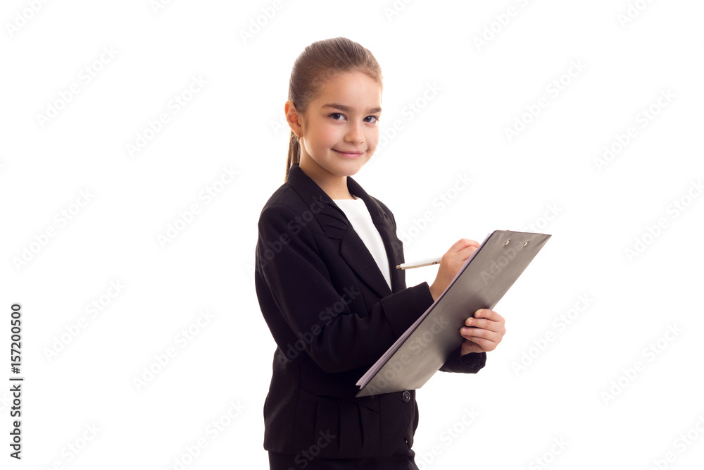 Little girl in black jacket holding pen and folder Little girl in black jacket holding pen and folder