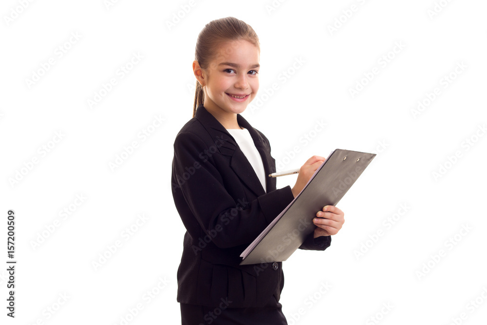 Little girl in black jacket holding pen and folder Little girl in black jacket holding pen and folder