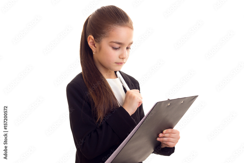 Little girl in black jacket holding pen and folder Little girl in black jacket holding pen and folder