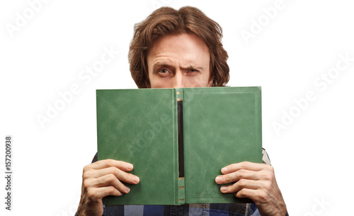 caucasian man with book looking at camera isolated on white background
