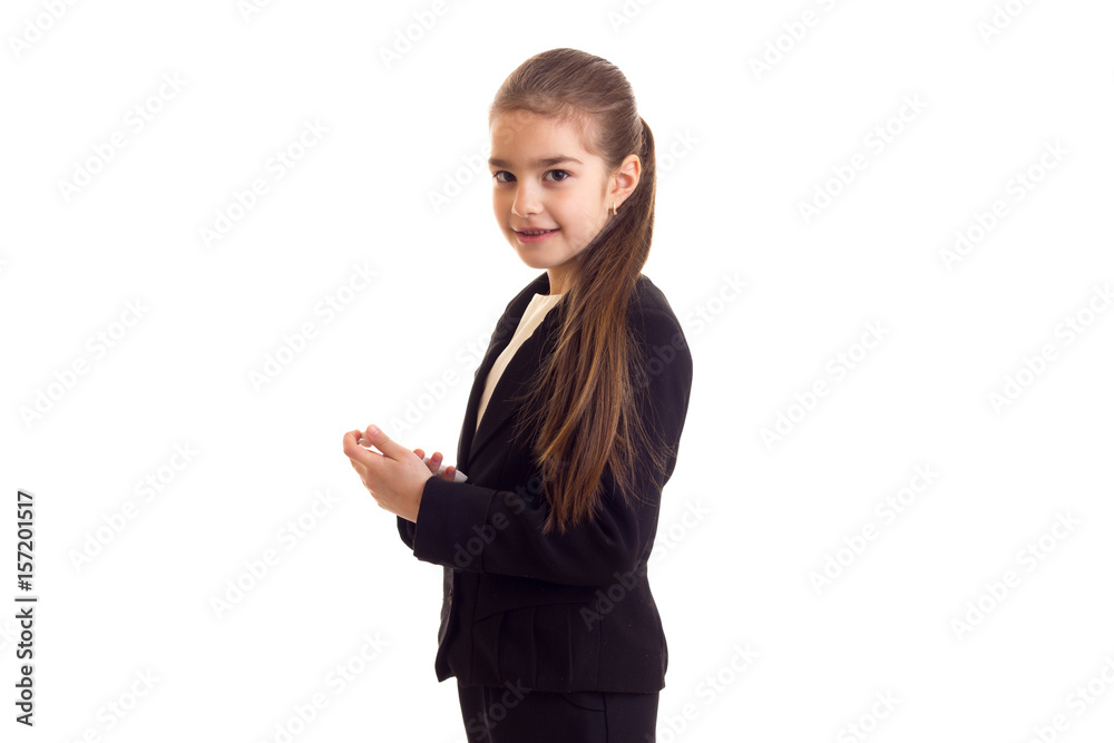 Little girl in black jacket holding phone Little girl in black jacket holding phone