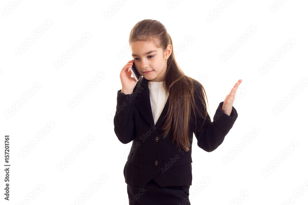 Little girl in black jacket talking on phone Little girl in black jacket talking on phone