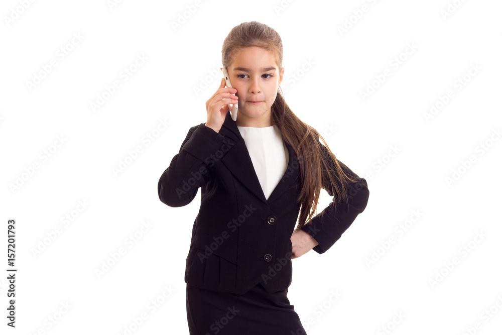 Little girl in black jacket talking on phone Little girl in black jacket talking on phone