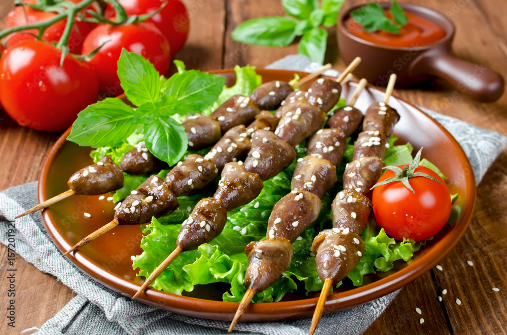 Chicken hearts on a barbecue sticks topped with sesame seeds Chicken hearts on a barbecue sticks topped with sesame seeds