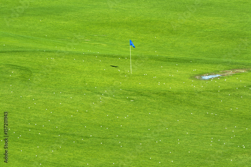 Vibrant golf course and target flag