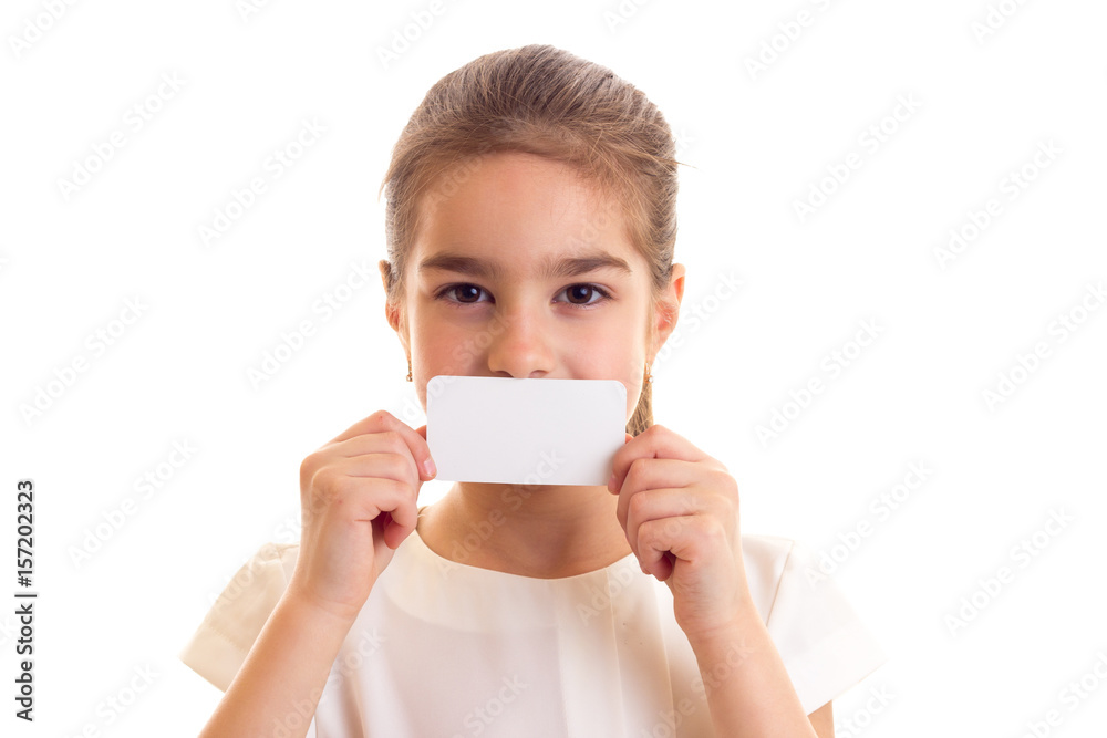 Little girl in white T-shirt holding white card Little girl in white T-shirt holding white card