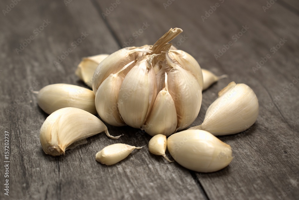 Garlic isolated on wooden background.