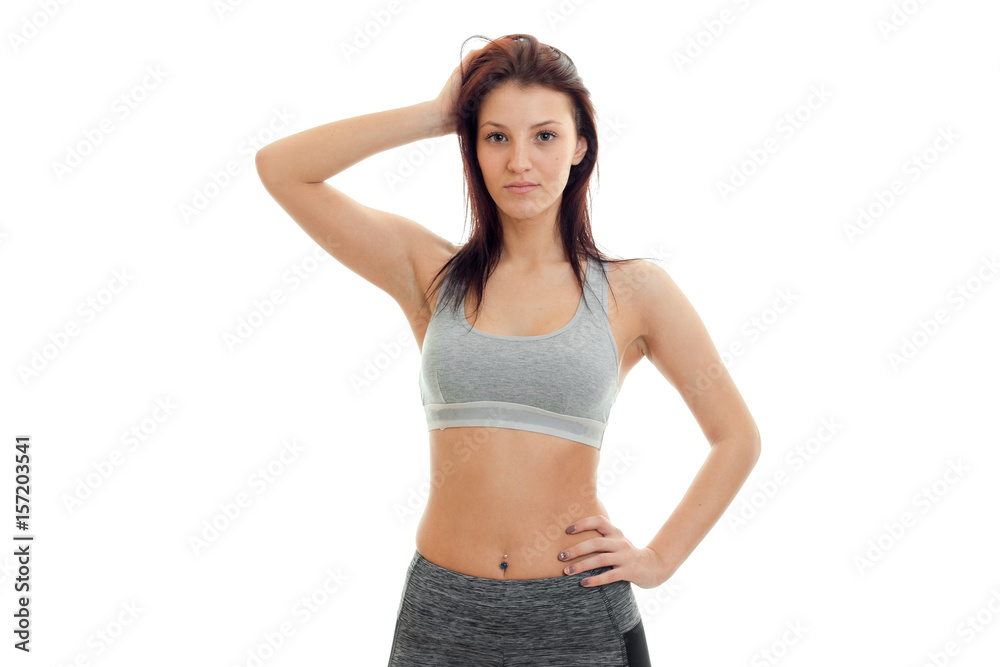 the charming slender girl with dark hair looks straight and keeps a hand on the side of the the charming slender girl with dark hair looks straight and keeps a hand on the side of the
