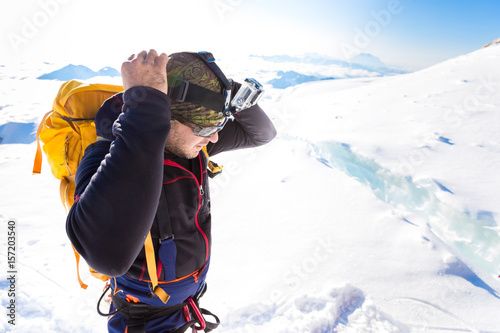  climber mountaineer standing mountain crevasse ridge Huayna Potosi Bolivia.