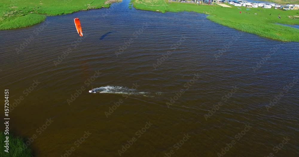 Aerial view of kitesurfing extreme sport with the wind freestyle. Beautiful top view of nice lagoon coast and kitespot Aerial view of kitesurfing extreme sport with the wind freestyle. Beautiful top view of nice lagoon coast and kitespot