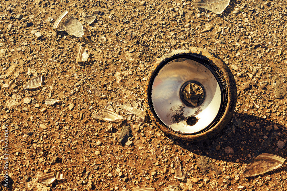 Antique truck broken headlight lying on the ground. close-up. Antique truck broken headlight lying on the ground. close-up.